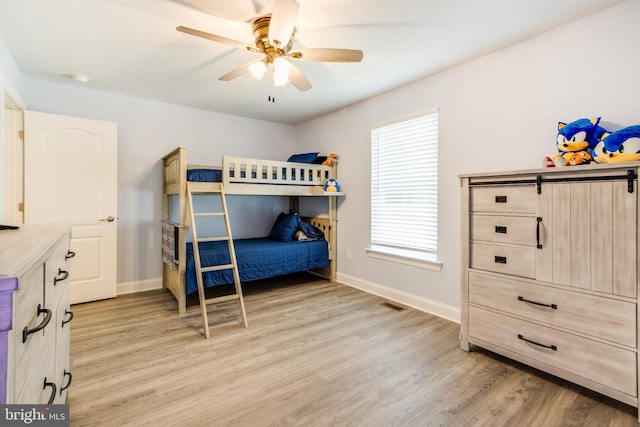 bedroom with ceiling fan and light hardwood / wood-style flooring