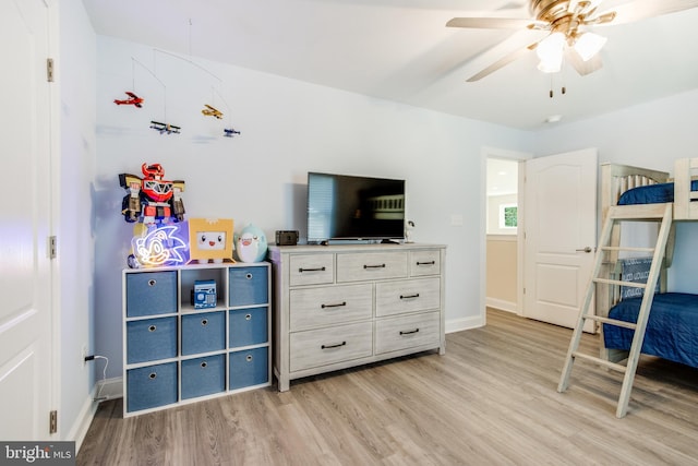 bedroom with ceiling fan and light wood-type flooring