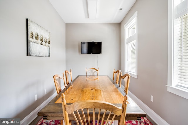 dining space featuring wood-type flooring