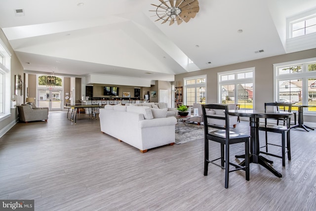 living room featuring hardwood / wood-style floors and high vaulted ceiling