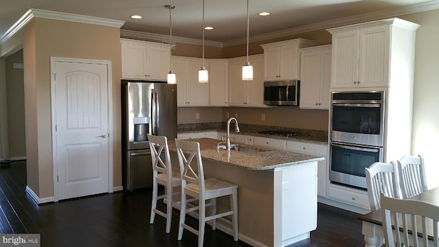 kitchen with white cabinetry, an island with sink, dark hardwood / wood-style floors, stainless steel appliances, and sink