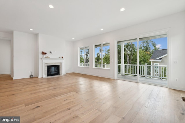 unfurnished living room featuring light wood-type flooring