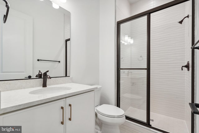 full bath featuring toilet, a shower stall, and vanity