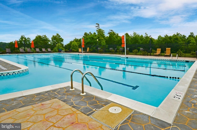 pool featuring a patio area and fence