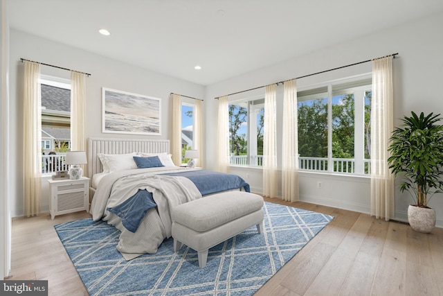 bedroom with recessed lighting, baseboards, and light wood finished floors