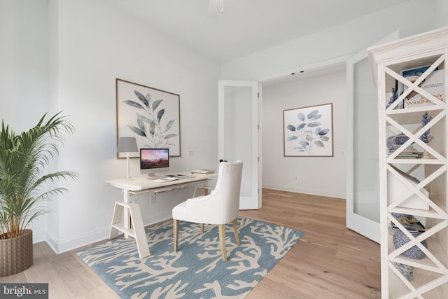 home office featuring baseboards and wood finished floors