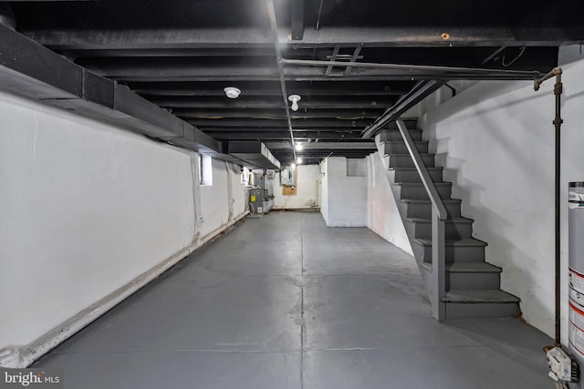 basement featuring electric panel and stairs