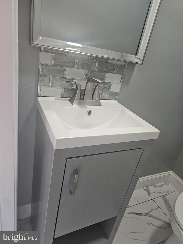 bathroom featuring vanity and toilet