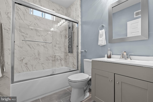 bathroom featuring tile patterned flooring, toilet, bath / shower combo with glass door, visible vents, and vanity