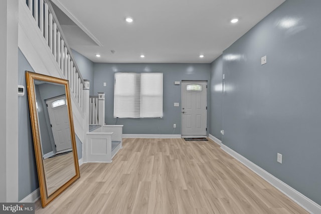 foyer entrance featuring stairway, recessed lighting, light wood-style flooring, and baseboards