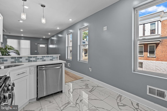 kitchen with stainless steel appliances, light countertops, visible vents, white cabinets, and baseboards