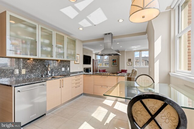 kitchen featuring light tile patterned flooring, light brown cabinets, backsplash, stainless steel appliances, and island exhaust hood