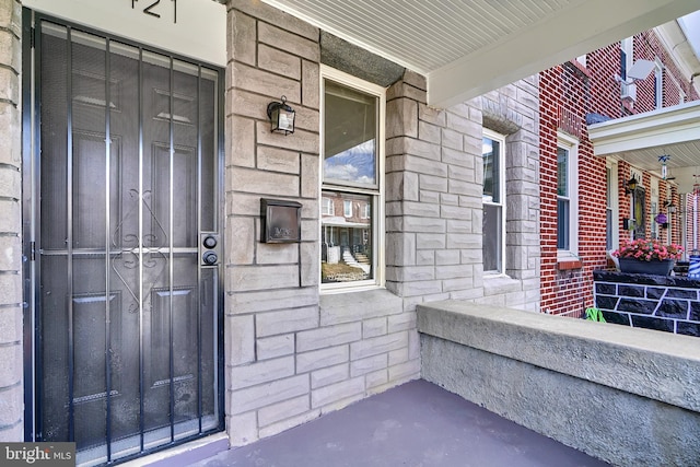 view of exterior entry with covered porch