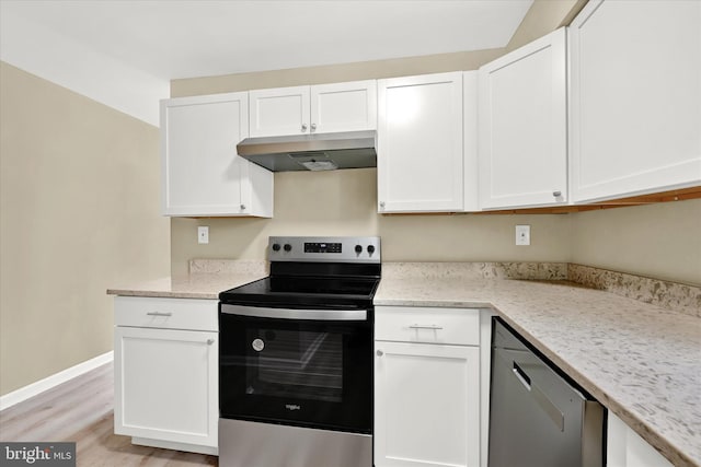 kitchen with light stone countertops, white cabinetry, appliances with stainless steel finishes, and light hardwood / wood-style floors