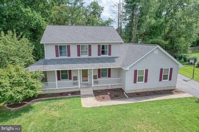 view of front of home with a porch and a front lawn