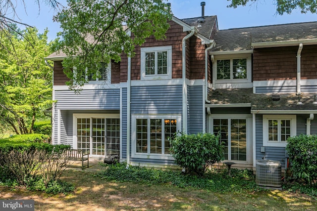 back of property featuring central AC unit