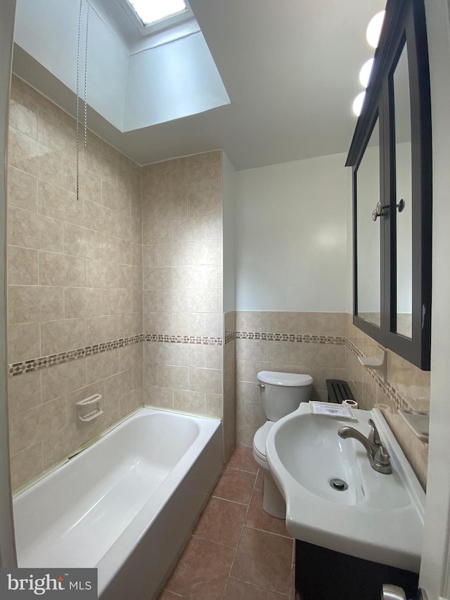 full bathroom featuring tile patterned flooring, a skylight, toilet, tile walls, and  shower combination