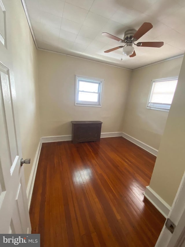 spare room featuring hardwood / wood-style floors and ceiling fan