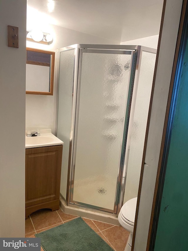 bathroom with walk in shower, tile patterned floors, toilet, and vanity