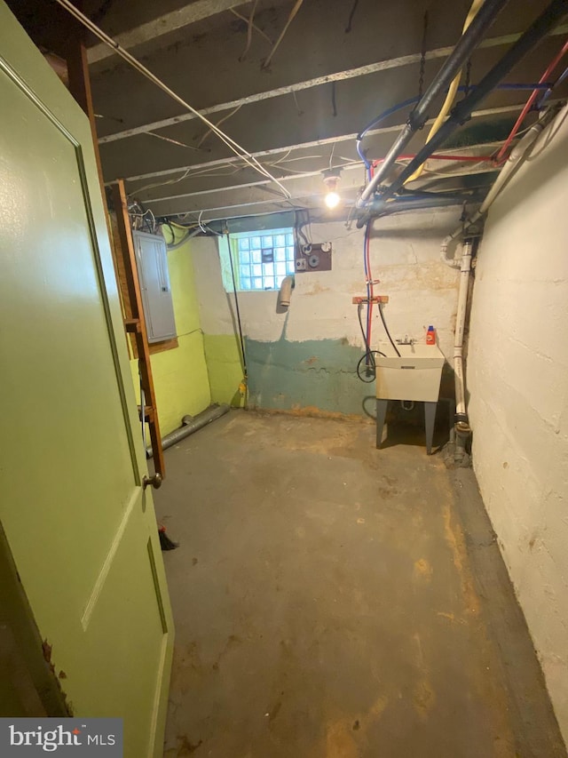 basement with electric panel and sink