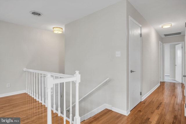 hallway with hardwood / wood-style flooring