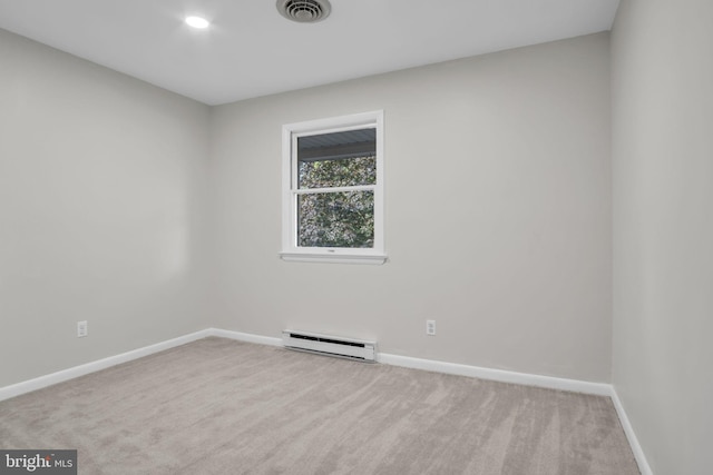 carpeted empty room featuring baseboard heating