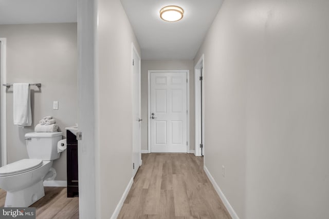 hallway with light hardwood / wood-style flooring