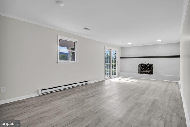 unfurnished living room with a brick fireplace, crown molding, a baseboard radiator, and light wood-type flooring