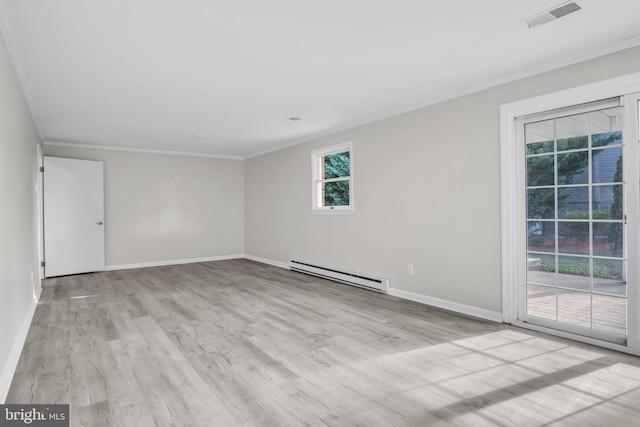 empty room with ornamental molding, a baseboard heating unit, and light wood-type flooring