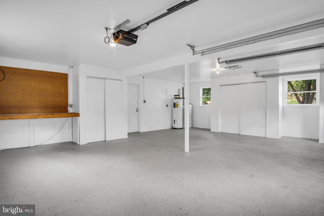 garage with a garage door opener and water heater