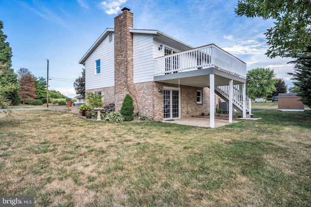 back of house featuring cooling unit, a yard, a patio area, and a deck