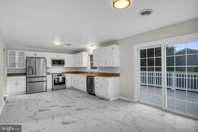 kitchen featuring white cabinets, appliances with stainless steel finishes, and light tile patterned floors