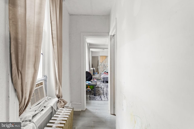 hallway with radiator and hardwood / wood-style flooring