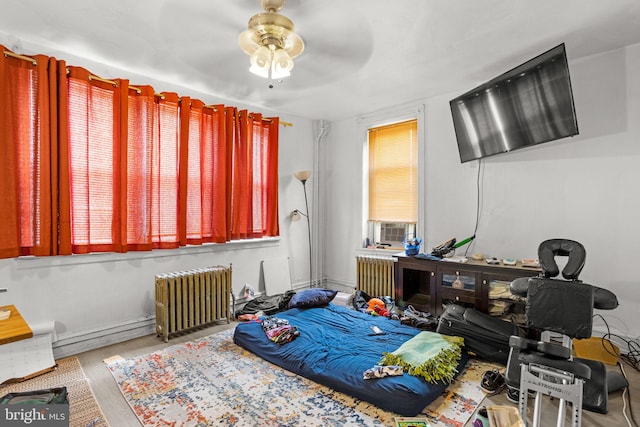 recreation room featuring radiator heating unit and ceiling fan