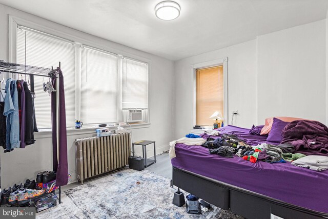 bedroom with radiator heating unit and cooling unit