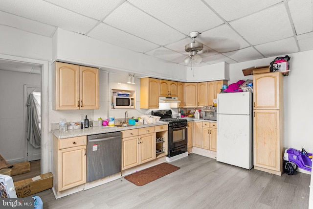 kitchen featuring black range with gas cooktop, light wood-type flooring, stainless steel dishwasher, and white refrigerator