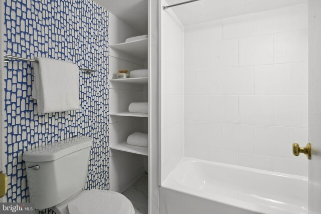 bathroom featuring shower / bathing tub combination, tile walls, and toilet