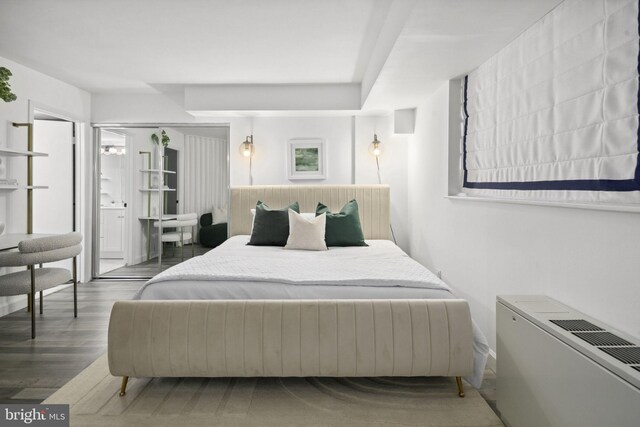 bedroom with dark wood-type flooring