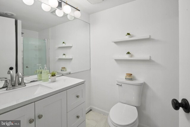 bathroom featuring vanity, toilet, and a shower with shower door