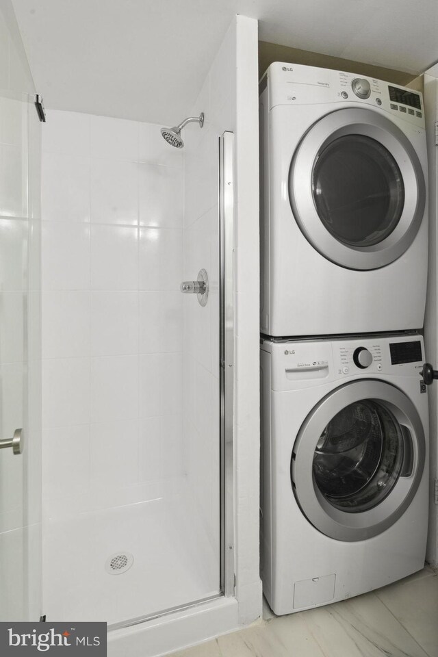 washroom featuring stacked washer and dryer