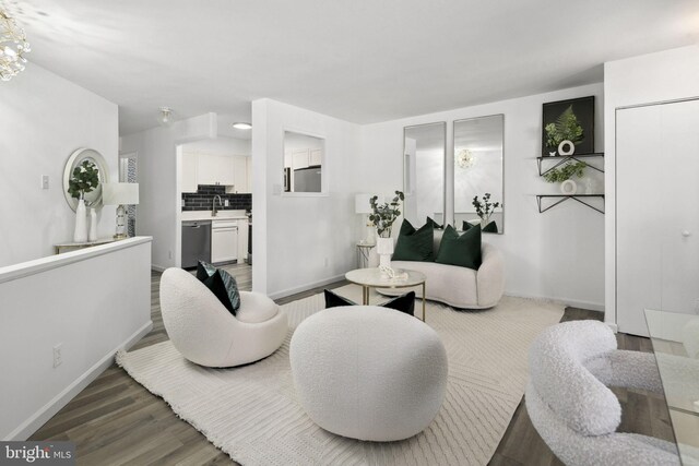 living room with sink and wood-type flooring