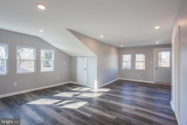 bonus room featuring plenty of natural light, dark hardwood / wood-style floors, and vaulted ceiling