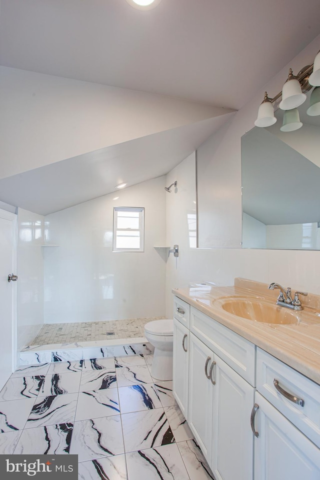 bathroom with vanity, walk in shower, vaulted ceiling, toilet, and tile patterned flooring