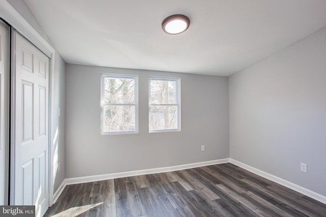 unfurnished bedroom with a closet and hardwood / wood-style flooring