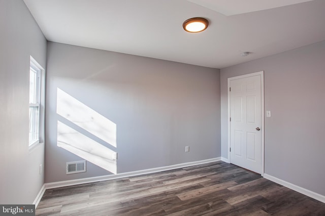 empty room featuring dark hardwood / wood-style flooring