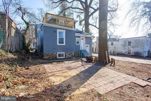 rear view of house featuring a balcony and a patio area