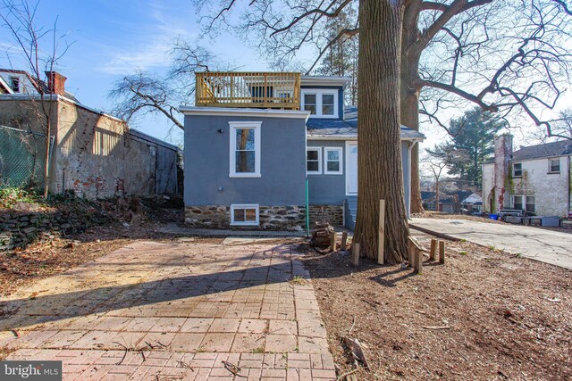 rear view of property with a balcony