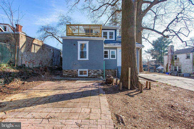 rear view of property with a balcony