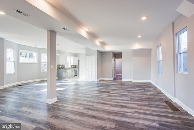 unfurnished living room featuring dark hardwood / wood-style floors