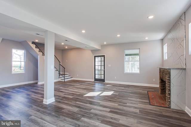 unfurnished living room featuring a fireplace and wood-type flooring